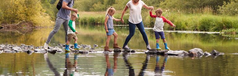 Family playing in river in Lancashire